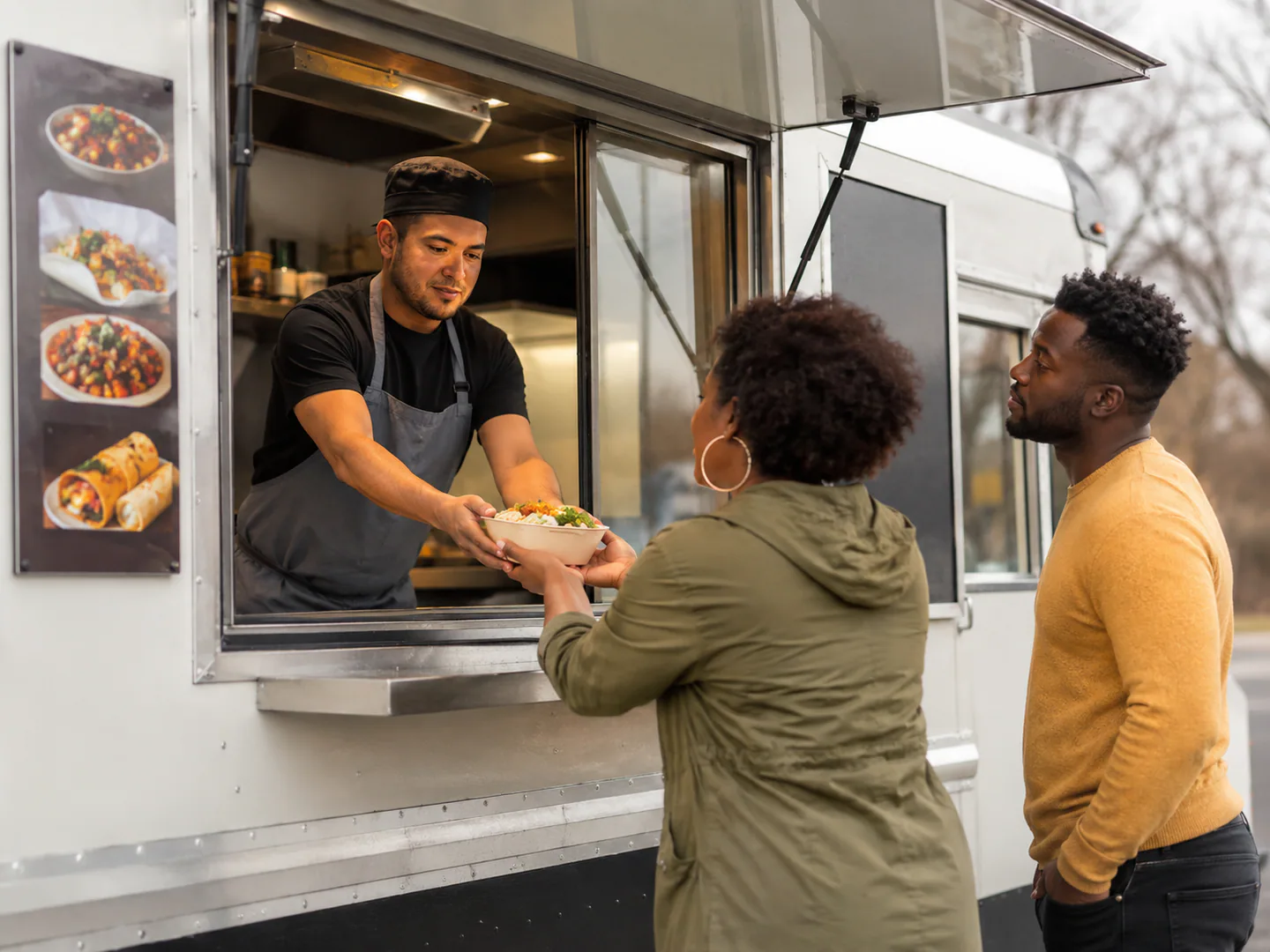 Food truck team serving customers from a clean mobile operation