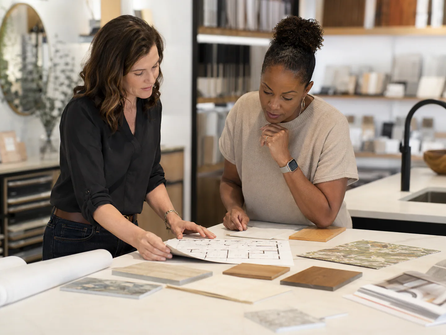 Interior designer presenting material and space options to a client