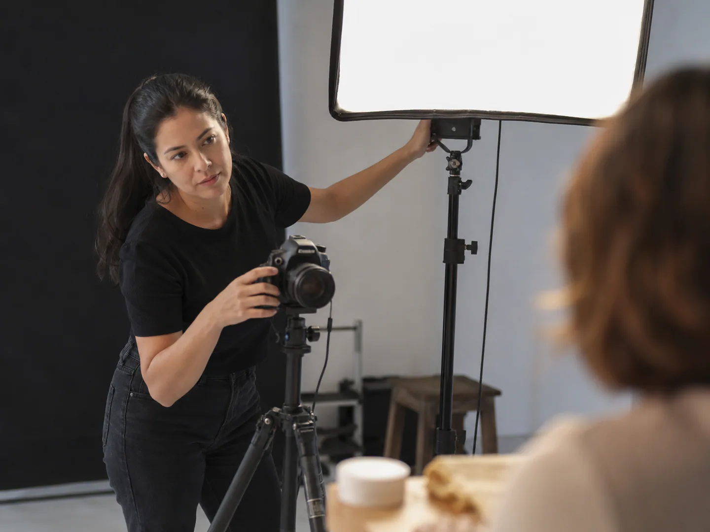 Professional photographer creating or reviewing an authentic client shoot