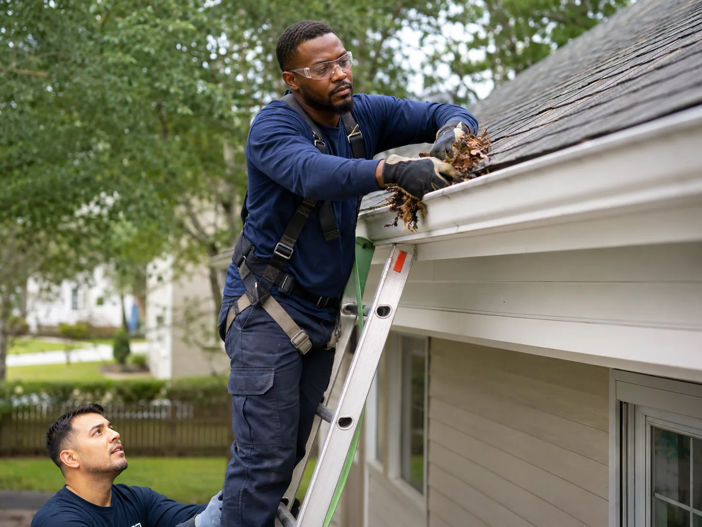 Gutter cleaning professional servicing a real residential property